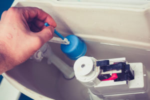 Réparation mécanisme chasse d'eau de WC suspendu à double poussoir